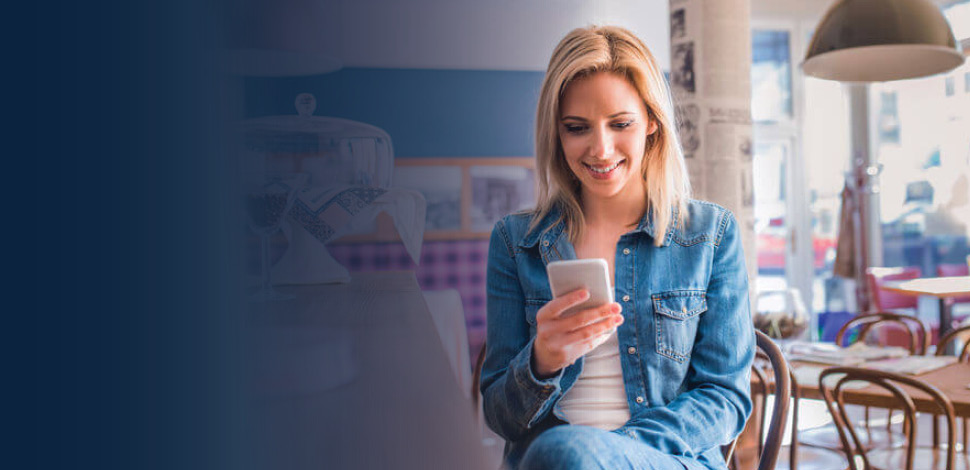 Woman checking phone in restaurant