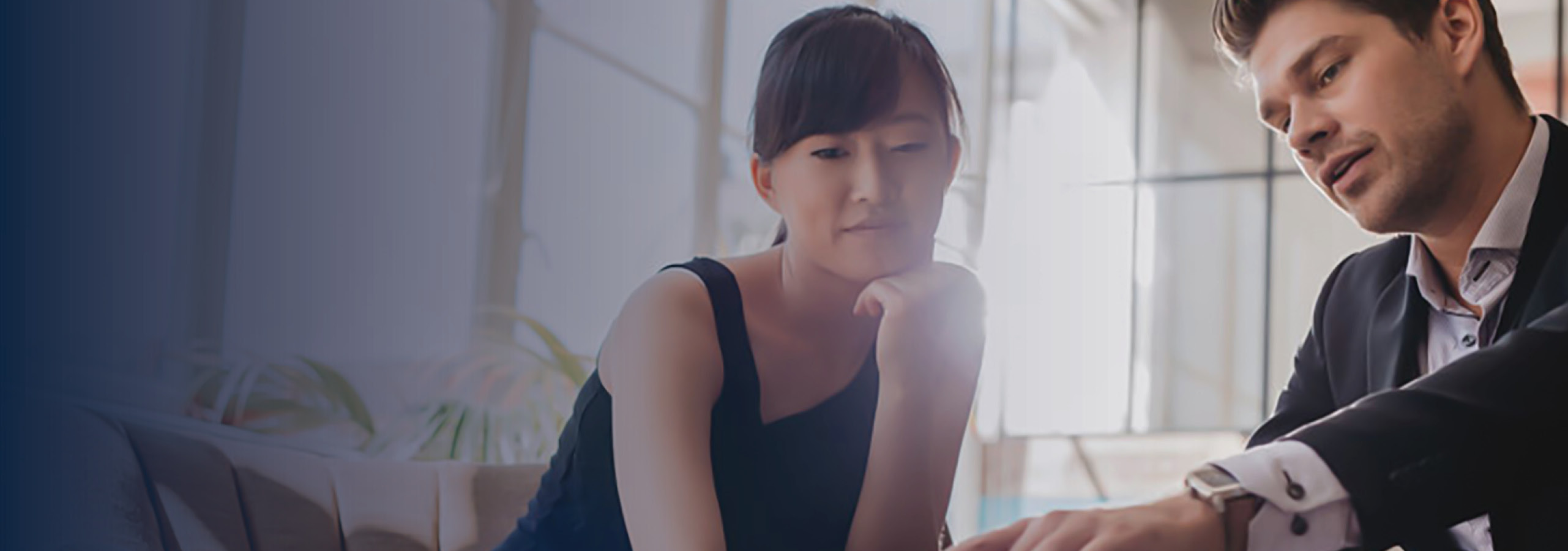 Business people reviewing information on a laptop.