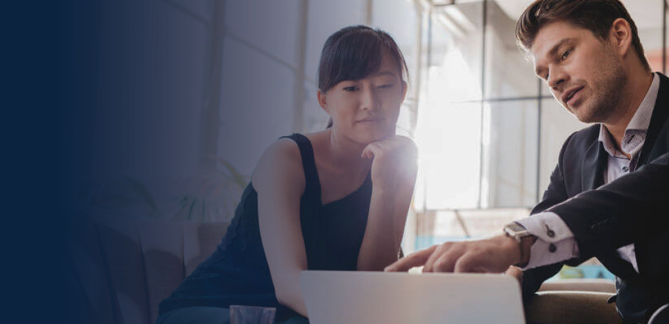 Business people reviewing information on a laptop.