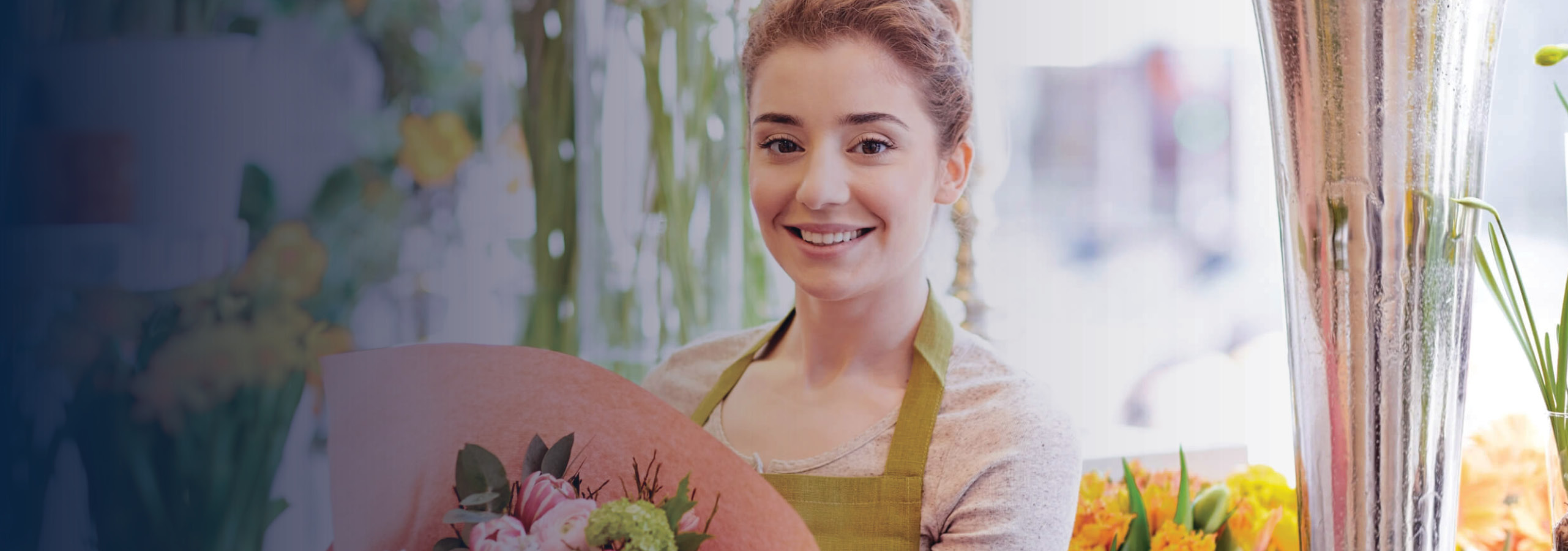 Female florist working in shop preparing a bouquet