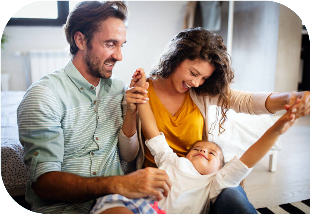 Mom and dad with young daughter on couch