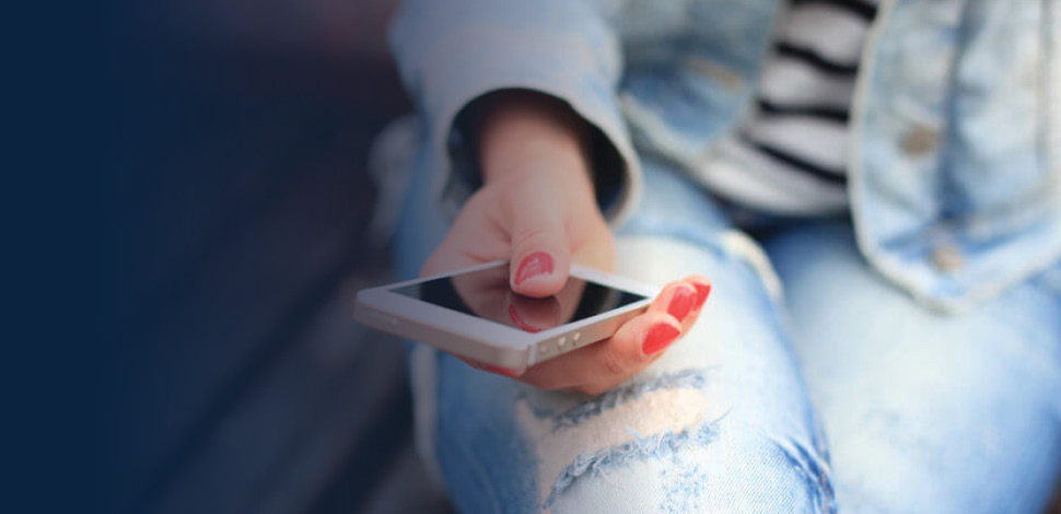 Close up of hand using cell phone