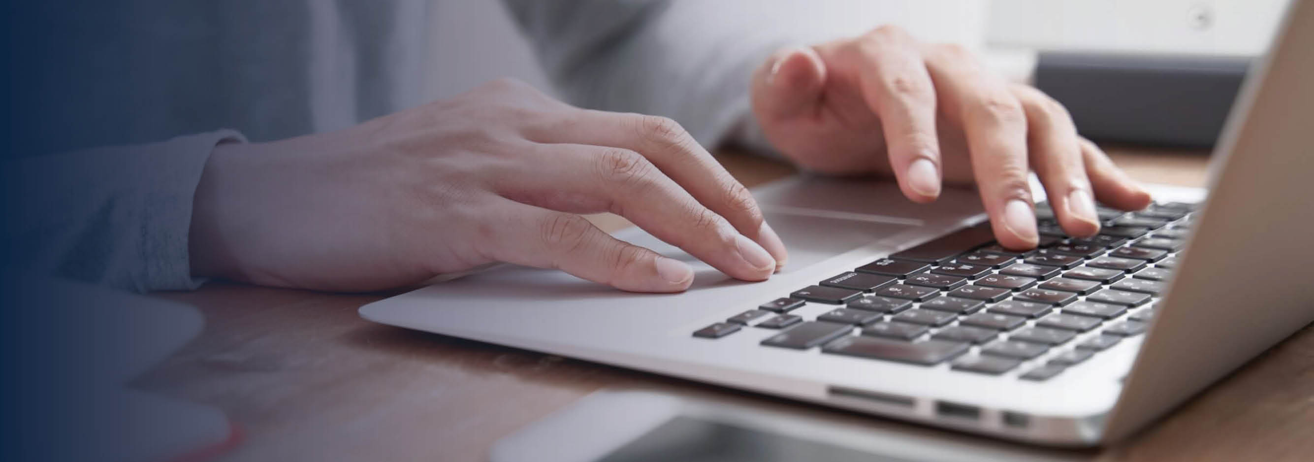 Close up of hands on laptop keyboard