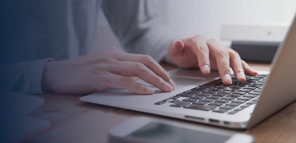 Close up of hands on laptop keyboard