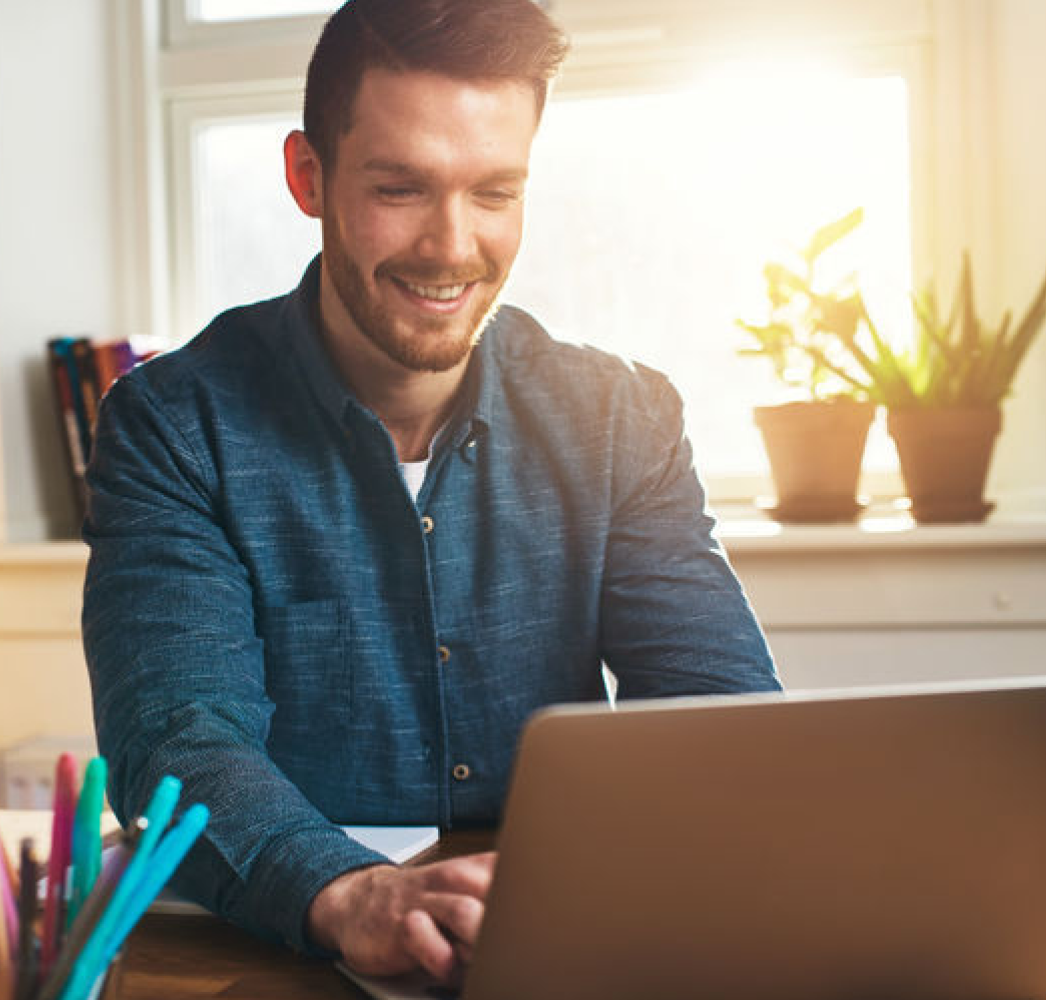 Man at home, viewing his laptop.