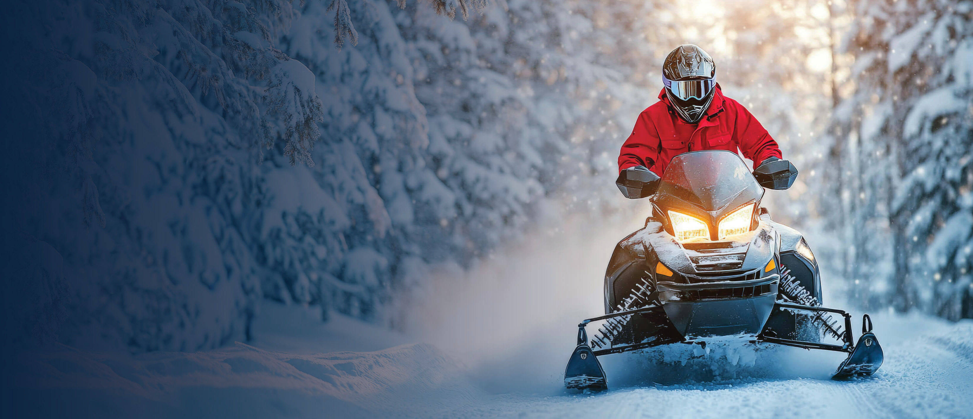 Snowmobile being driven through a forest.