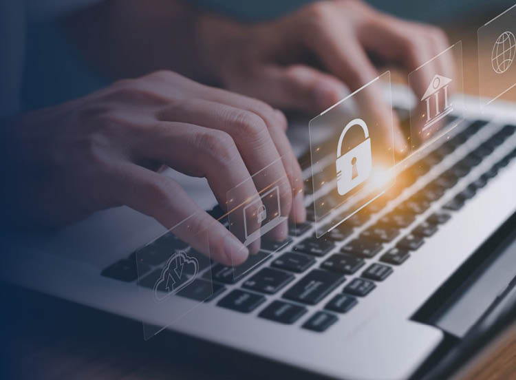 Close up of hands using a laptop with security icons layered on top.