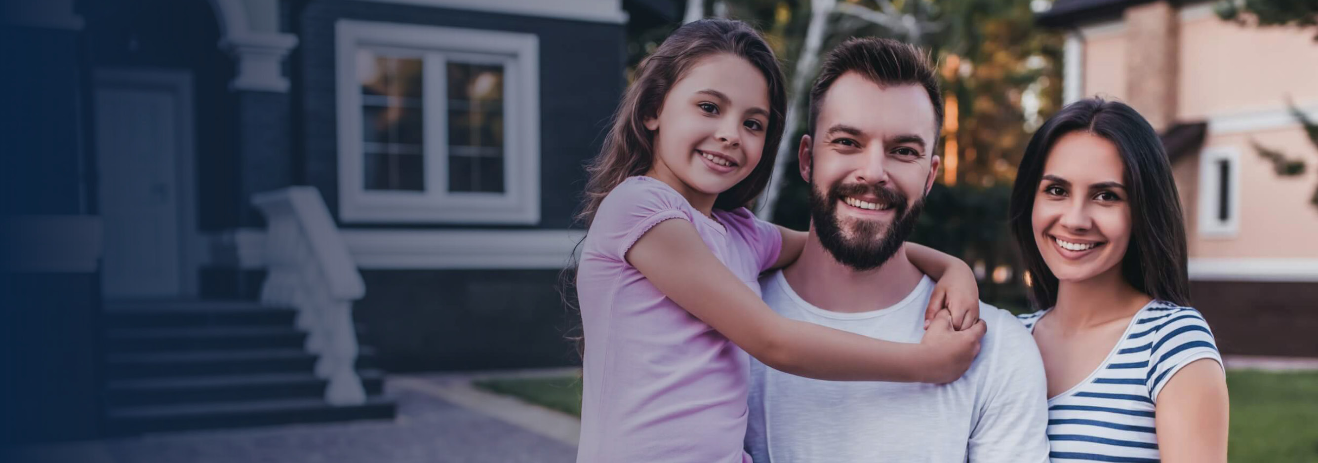 Family standing in front of their home