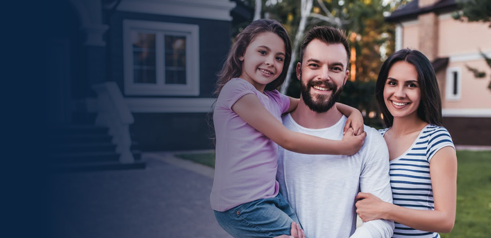 Family standing in front of their home