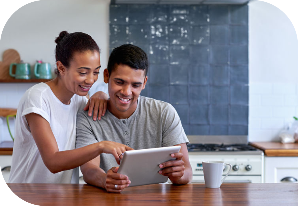 Young couple looking at tablet in the kitchen