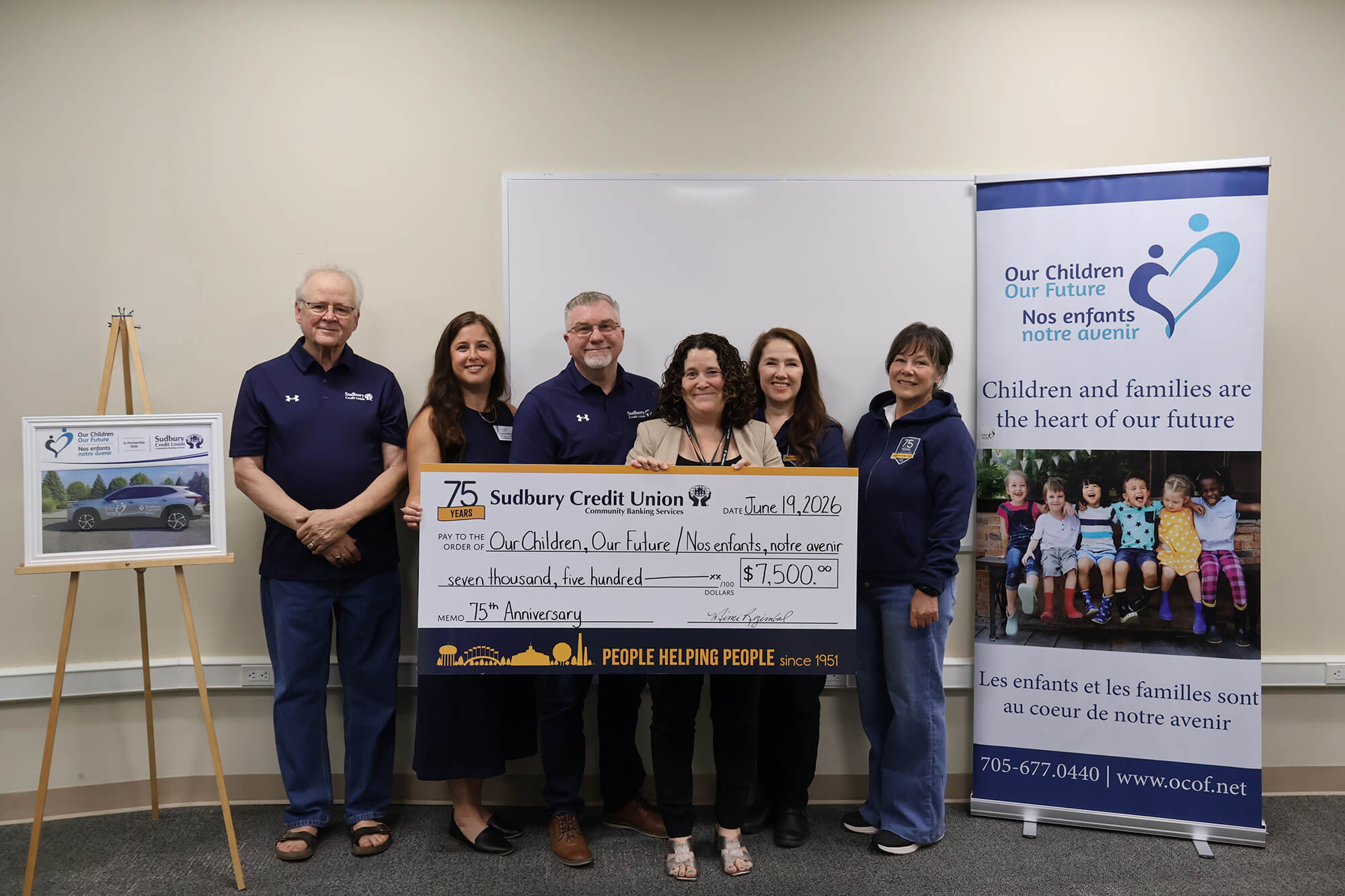 SCU staff present a cheque for $7,500 to Our Children, Our Future