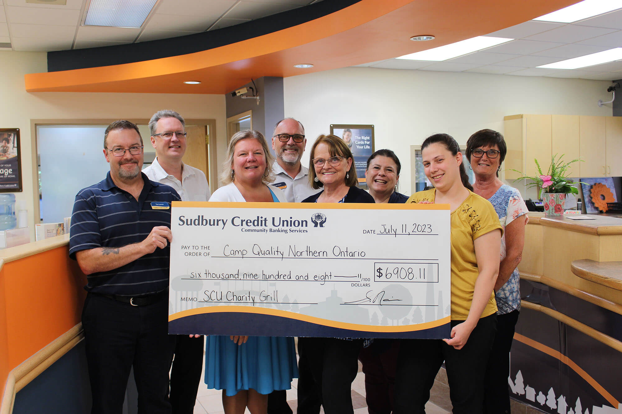 SCU staff present a cheque to Camp Quality Northern Ontario for $6908.11