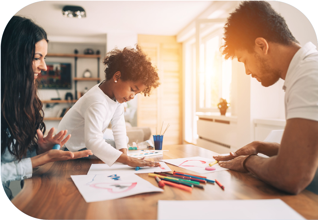 Young family colouring together at kitchen table