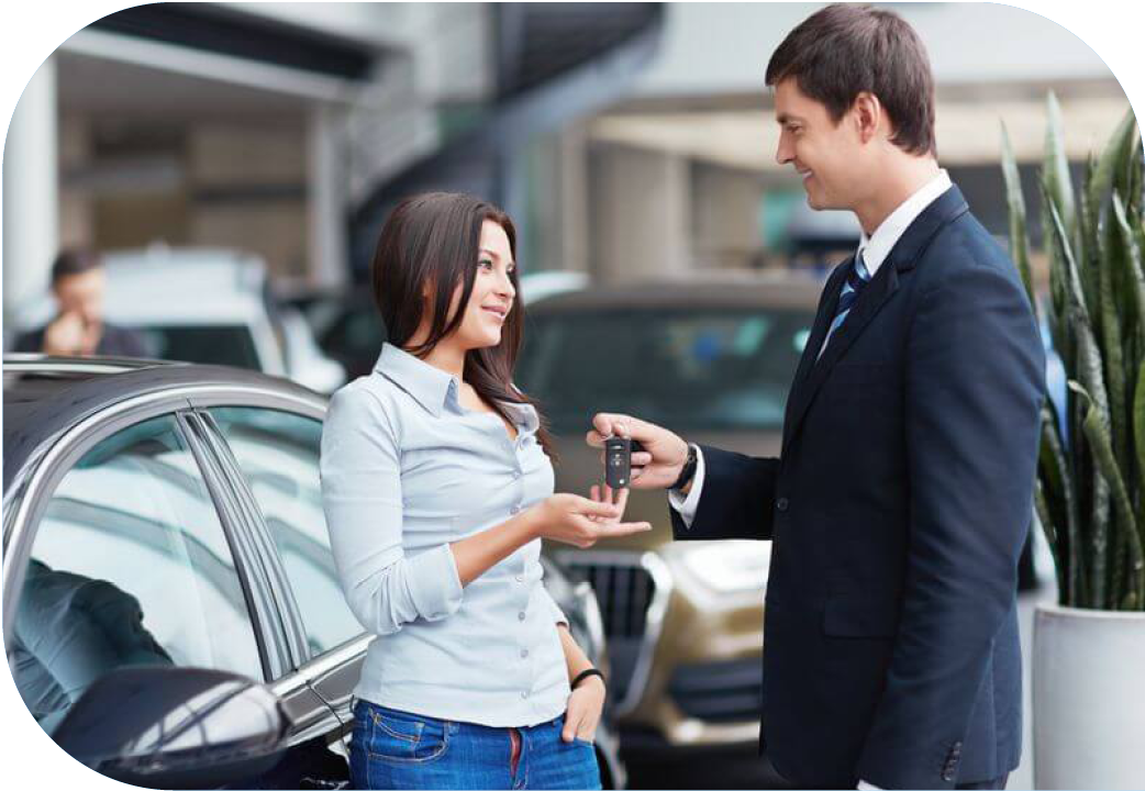 A woman receiving keys to her new car