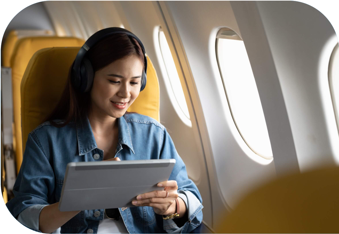 Woman using a tablet while on an airplane