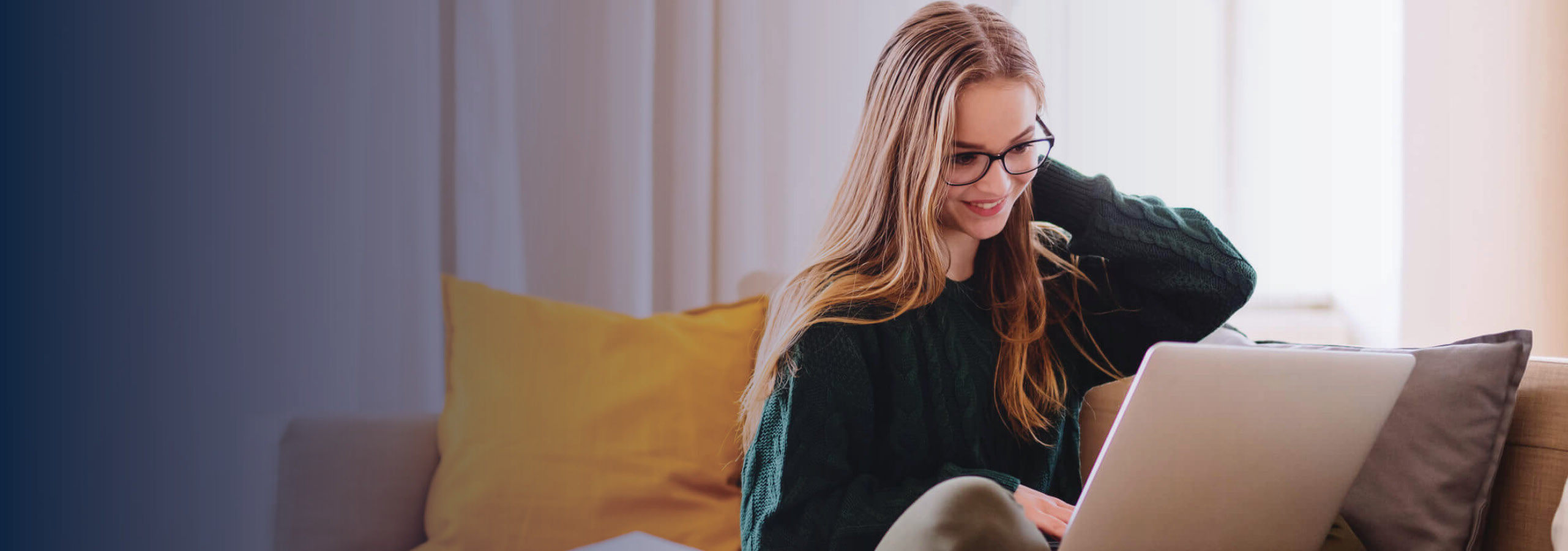 Woman sitting on couch with laptop