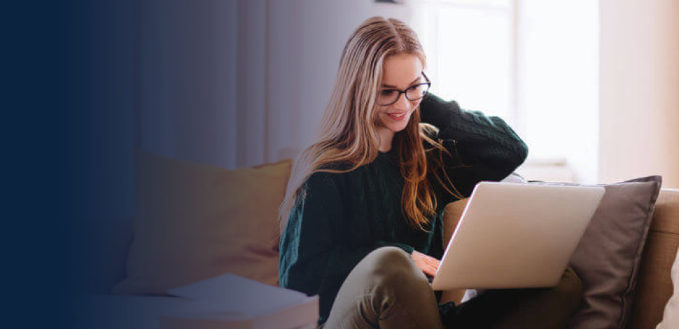 Woman sitting on couch with laptop