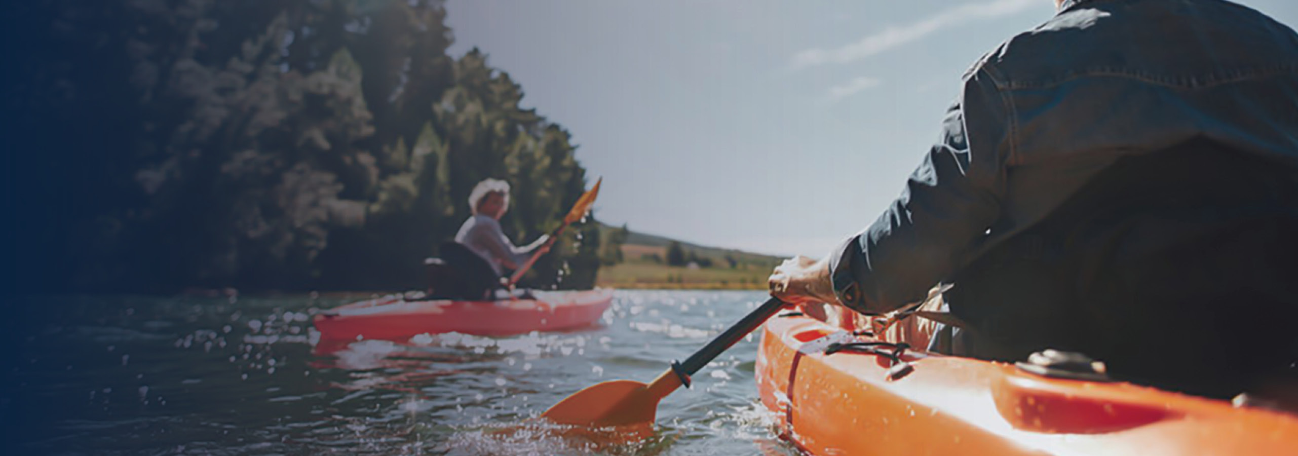 Senior couple canoeing in the lake on a sunny day