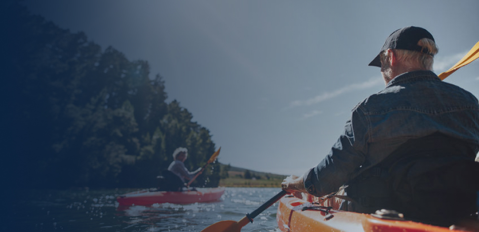 Senior couple canoeing in the lake on a sunny day