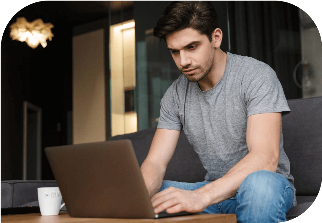 Man at home, using a laptop.