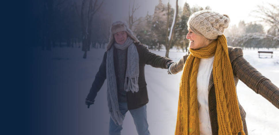 Retired couple holding hands while ice skating