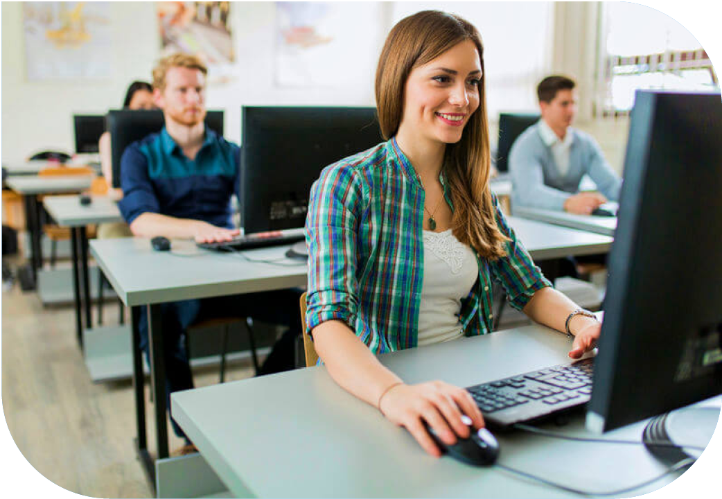 Female student in class, sitting at a computer