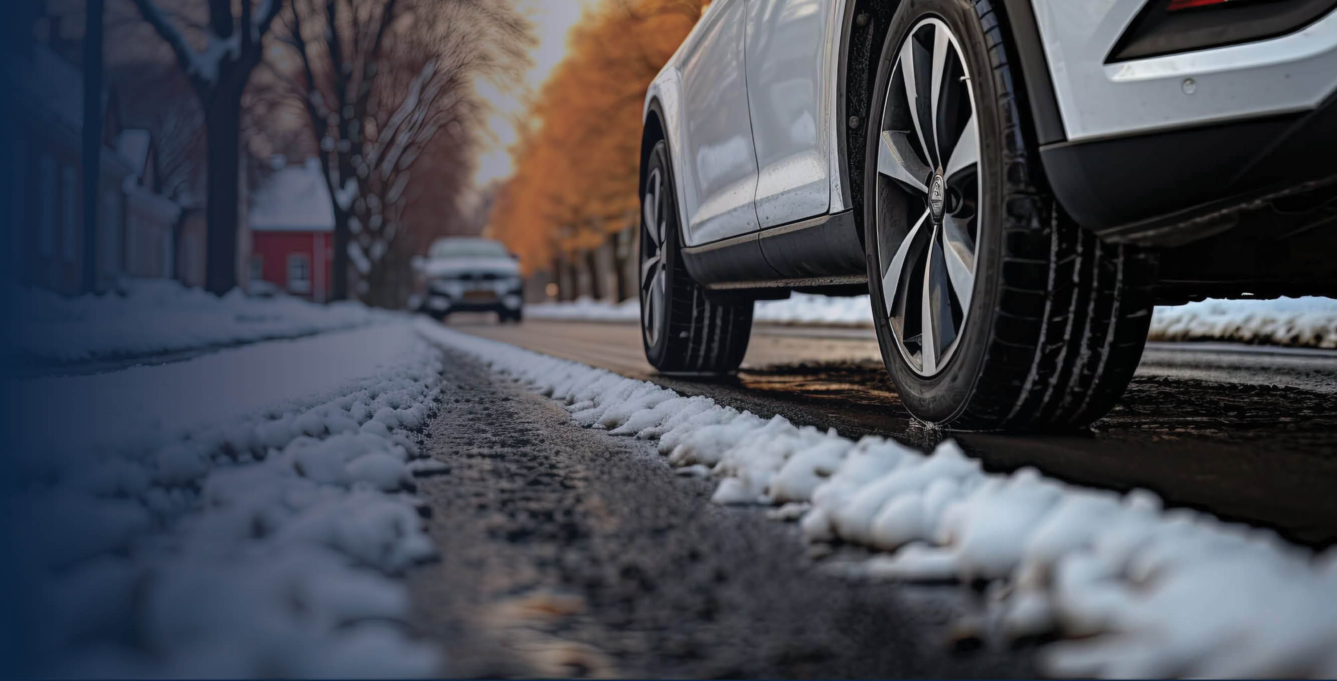 Car driving on snow covered street.