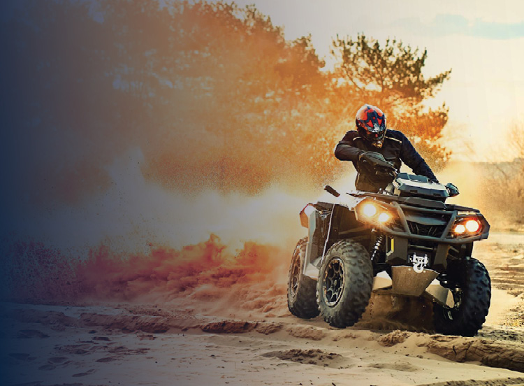 Quad driving through mud