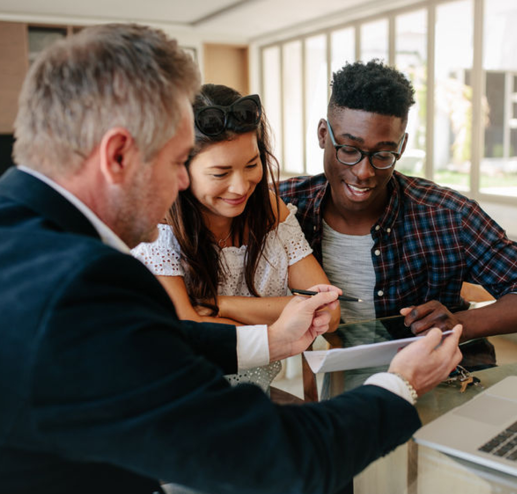 Young happy couple signing documents to buy new house